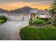 Two-car garage, landscaped yard, and inviting front entrance at 2410 Little Mountain Loop, The Villages, FL 32162