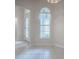Dining area with tile floor and arched window at 2410 Little Mountain Loop, The Villages, FL 32162