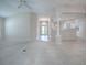 Spacious living room with tile and carpet flooring, access to the backyard, and neutral color palette at 2410 Little Mountain Loop, The Villages, FL 32162