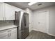 Sleek kitchen with stainless steel refrigerator and white cabinets at 500 E Lakeview Ave, Eustis, FL 32726