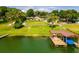 Covered boat dock on the lake with a blue boat cover at 2537 E Crooked Lake Dr, Eustis, FL 32726