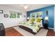 Bedroom with a king-size bed and tropical-themed bedding at 2537 E Crooked Lake Dr, Eustis, FL 32726