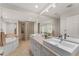 Bathroom with double sinks, soaking tub, and glass block shower at 2537 E Crooked Lake Dr, Eustis, FL 32726