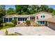 Two-story house with stone accents, landscaping, and a large driveway at 2537 E Crooked Lake Dr, Eustis, FL 32726