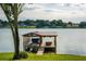Covered boat dock with lift and spacious deck at 2537 E Crooked Lake Dr, Eustis, FL 32726