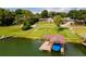 Covered boat dock with a large deck and a blue boat cover at 2537 E Crooked Lake Dr, Eustis, FL 32726