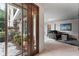 Entryway with wooden door and view into living room at 2537 E Crooked Lake Dr, Eustis, FL 32726