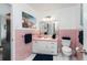 Retro bathroom with pink tile and white vanity at 2537 E Crooked Lake Dr, Eustis, FL 32726