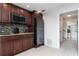 Compact kitchen with dark wood cabinets and modern appliances at 2537 E Crooked Lake Dr, Eustis, FL 32726