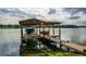 Covered boat dock with lift and spacious deck at 2537 E Crooked Lake Dr, Eustis, FL 32726