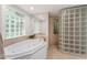 Bathroom with soaking tub and glass block shower at 2537 E Crooked Lake Dr, Eustis, FL 32726