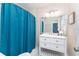 Bathroom with a teal shower curtain and white vanity at 2537 E Crooked Lake Dr, Eustis, FL 32726