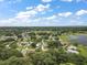 Community overview: large lake, numerous houses and lush green landscape at 25043 Bellevue, Leesburg, FL 34748
