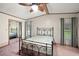 Main bedroom with mirrored closet doors and ceiling fan at 25043 Bellevue, Leesburg, FL 34748