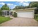 Single-story home with attached garage and lush landscaping at 25043 Bellevue, Leesburg, FL 34748