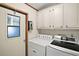 Laundry room with washer, dryer, and cabinets at 25043 Bellevue, Leesburg, FL 34748