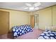 Bedroom with two twin beds and ceiling fan at 25043 Bellevue, Leesburg, FL 34748