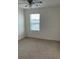 Spacious bedroom with carpeted floor and window at 6904 Church Lake St, Groveland, FL 34736