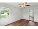 Bedroom with wood-look floors and mirrored closet at 54 Aberdeen Cir, Leesburg, FL 34788