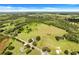 Wide shot of property with home, pond, and large pasture at 13832 Bay Lake Rd, Groveland, FL 34736