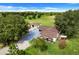 Aerial view of a house with detached garage and large fenced yard at 13832 Bay Lake Rd, Groveland, FL 34736