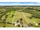 Wide shot of property with home, pond, and large pasture at 13832 Bay Lake Rd, Groveland, FL 34736