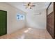 Spacious bedroom with tiled floor, ceiling fan, and large windows at 13832 Bay Lake Rd, Groveland, FL 34736
