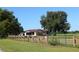 A ranch style house with attached garage and wooden fence at 13832 Bay Lake Rd, Groveland, FL 34736