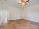 Bright living room with wood-look flooring and two ceiling fans at 13832 Bay Lake Rd, Groveland, FL 34736