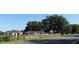 Road view of a house with attached garage and wooden fence at 13832 Bay Lake Rd, Groveland, FL 34736
