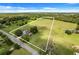 Aerial view showing house and large lot with pond in background at 13832 Bay Lake Rd, Groveland, FL 34736