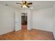 Bedroom with hardwood floors and access to another room at 13832 Bay Lake Rd, Groveland, FL 34736