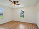 Well-lit bedroom with wood floors and dual windows at 13832 Bay Lake Rd, Groveland, FL 34736