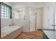 Bathroom boasts a soaking tub, walk-in shower, and modern fixtures at 13832 Bay Lake Rd, Groveland, FL 34736