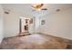 Spacious living room, tile floor, and view into kitchen at 13832 Bay Lake Rd, Groveland, FL 34736