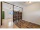 Living room with tiled and wood floors and room divider at 13832 Bay Lake Rd, Groveland, FL 34736
