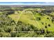 Wide shot of property with home, pond, and large pasture at 13832 Bay Lake Rd, Groveland, FL 34736