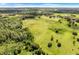 Aerial view of expansive property with lush green pastures and trees at 13832 Bay Lake Rd, Groveland, FL 34736