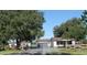 A charming ranch-style house with a gated entrance and large yard at 13832 Bay Lake Rd, Groveland, FL 34736