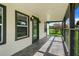 Front porch with tile flooring and decorative railing at 13832 Bay Lake Rd, Groveland, FL 34736