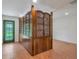 Inviting entryway with wood room divider and green door at 13832 Bay Lake Rd, Groveland, FL 34736