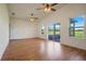 Main bedroom with wood flooring, high ceiling, and access to patio at 13832 Bay Lake Rd, Groveland, FL 34736