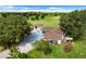 Aerial view of a house with detached garage and large fenced yard at 13832 Bay Lake Rd, Groveland, FL 34736