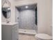 Bathroom with a large walk-in shower and gray vanity at 13832 Bay Lake Rd, Groveland, FL 34736