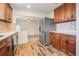 Modern kitchen with wood cabinets, stainless steel appliances, and tile flooring at 13832 Bay Lake Rd, Groveland, FL 34736