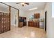 Open living area with kitchenette, built-in shelving, and decorative screen at 13832 Bay Lake Rd, Groveland, FL 34736