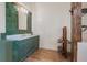 Bathroom with green tile, marble countertop, and green cabinets at 13832 Bay Lake Rd, Groveland, FL 34736
