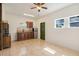 Bright studio with kitchenette, ceiling fan, and green accent door at 13832 Bay Lake Rd, Groveland, FL 34736