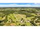 Wide shot of property with home, pond, and large pasture at 13832 Bay Lake Rd, Groveland, FL 34736