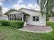 Home exterior showcasing a white-sided house with a sunroom and patio at 536 Grand Vista Trl, Leesburg, FL 34748